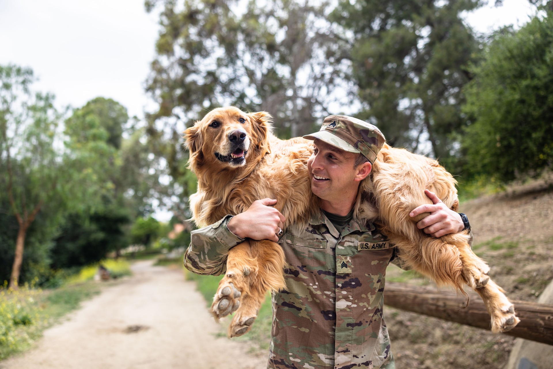 US Army Veteran Reunites with his Golden Retriever Dog Carrying on shoulders